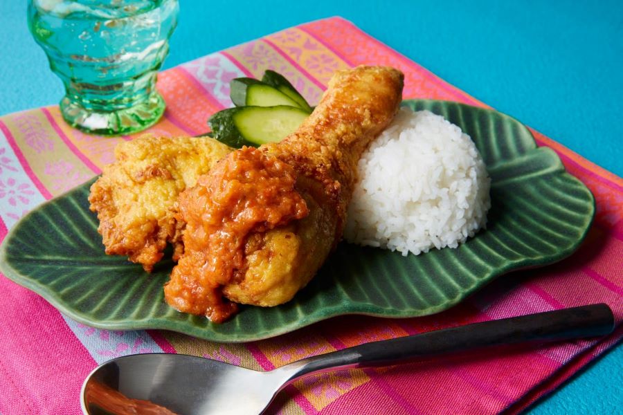 Nasi Katok consists of white rice (Nasi) served with a piece of fried chicken (Ayam Goreng).